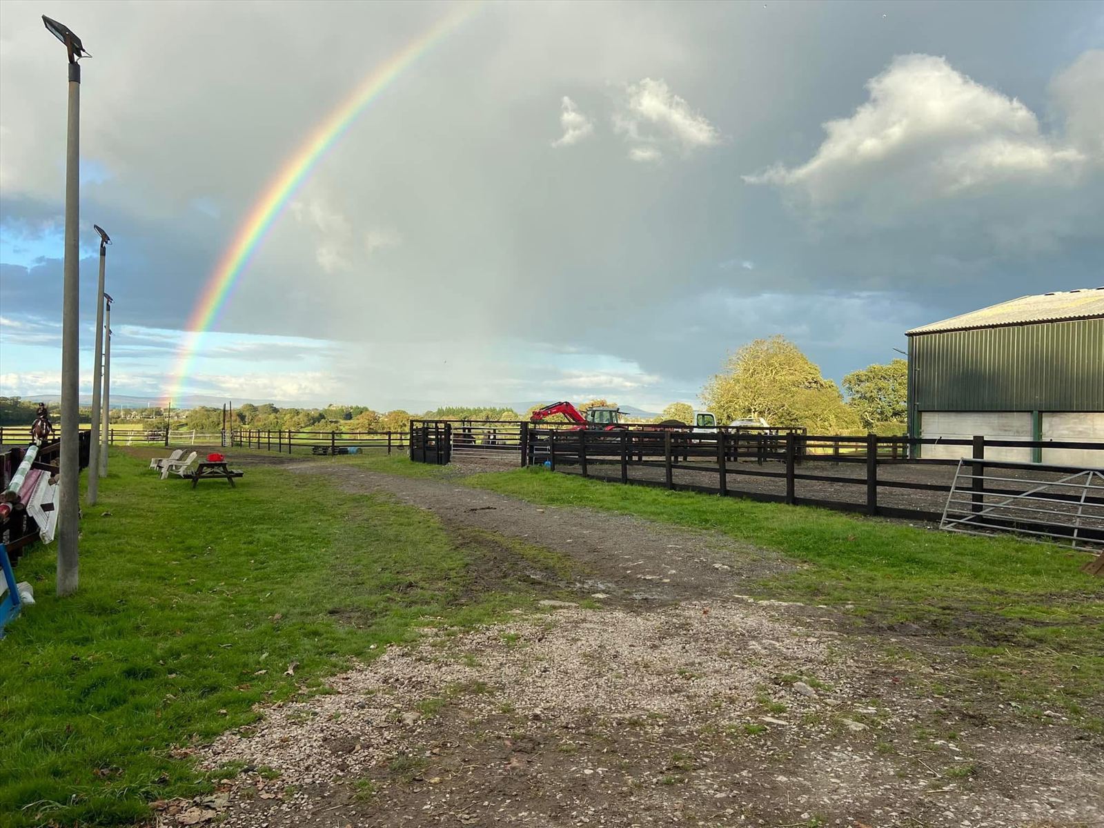 Rainbow over the open off-grid campsite and pitch area