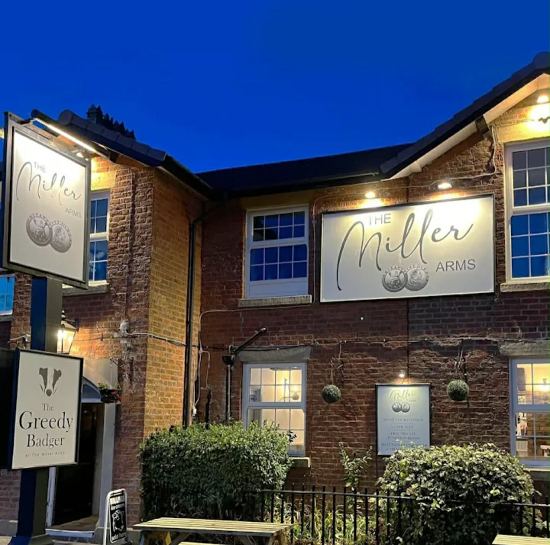 The Miller's Arms brick exterior illuminated in the evening