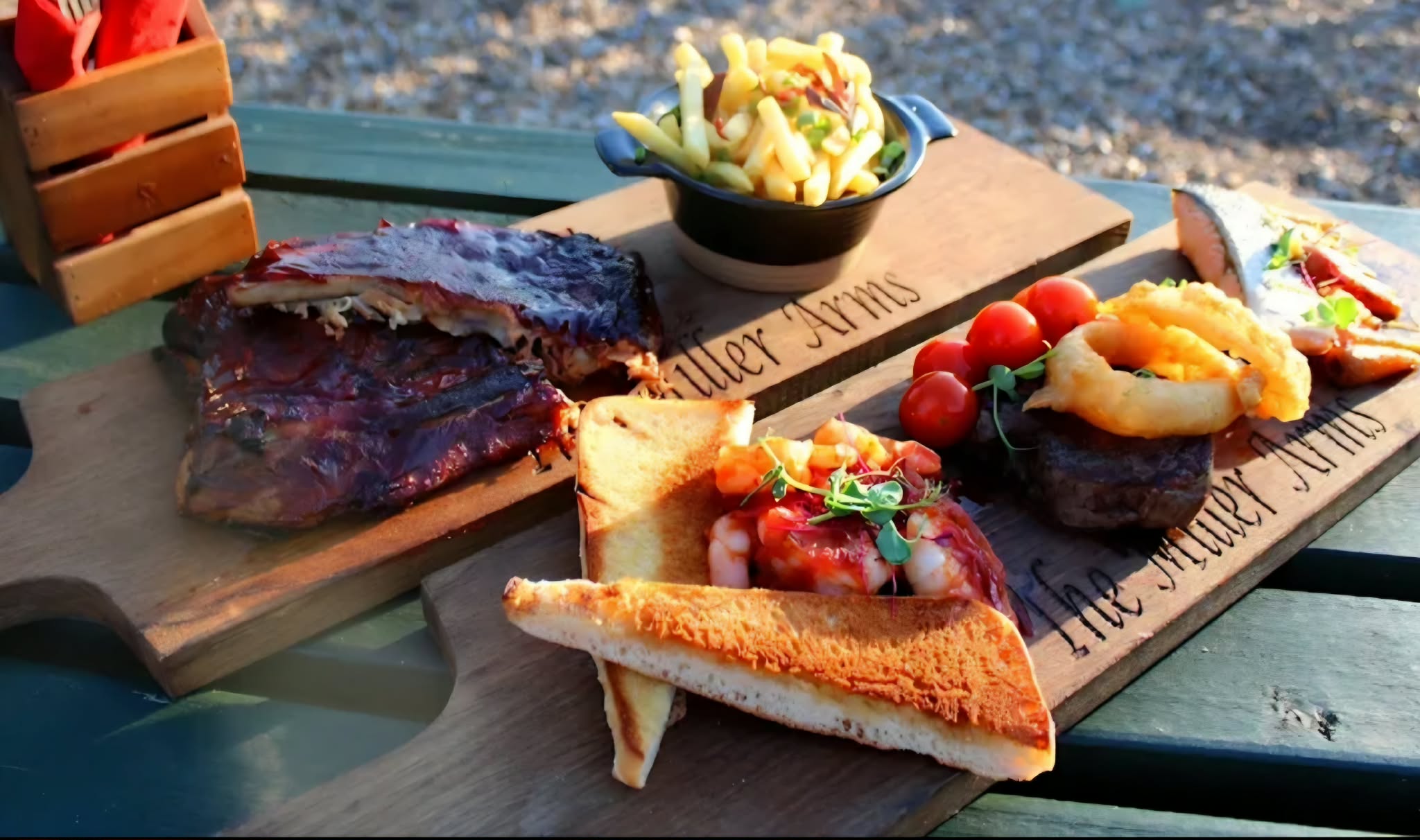 Selection of sharing dishes served outdoors at The Miller's Arms