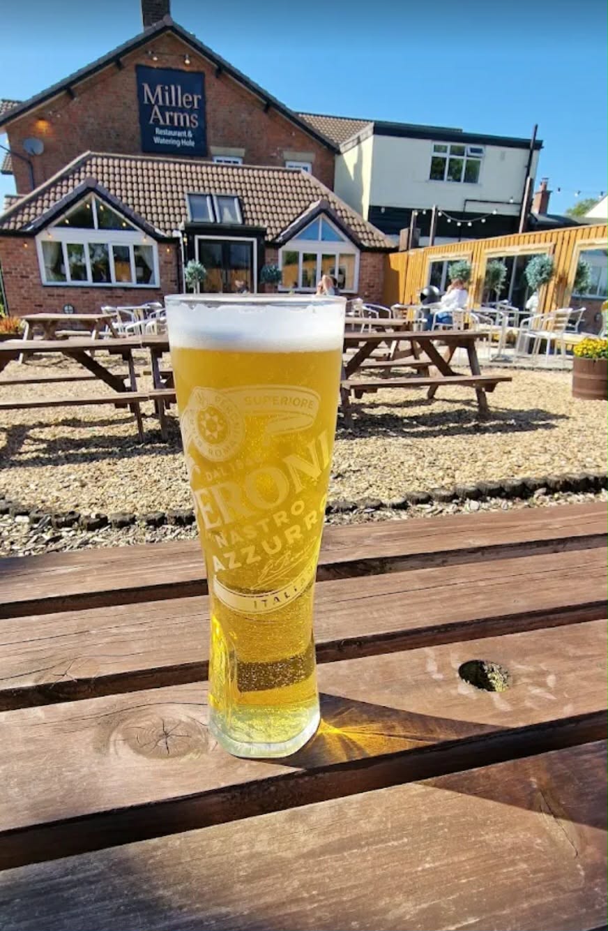 Outdoor seating at The Miller's Arms on a sunny day