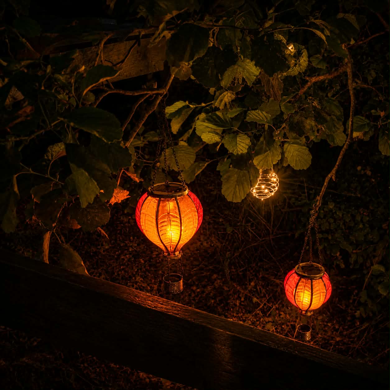 Warm lanterns glowing among leafy branches