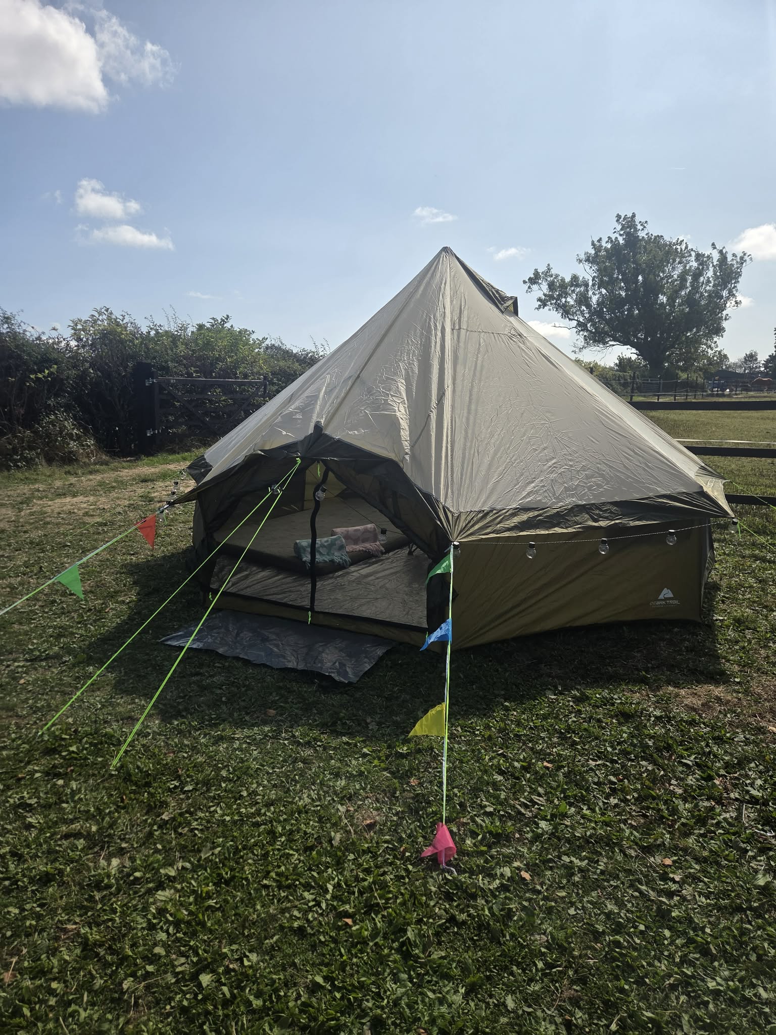 T-Pee set up in the countryside beneath a blue sky