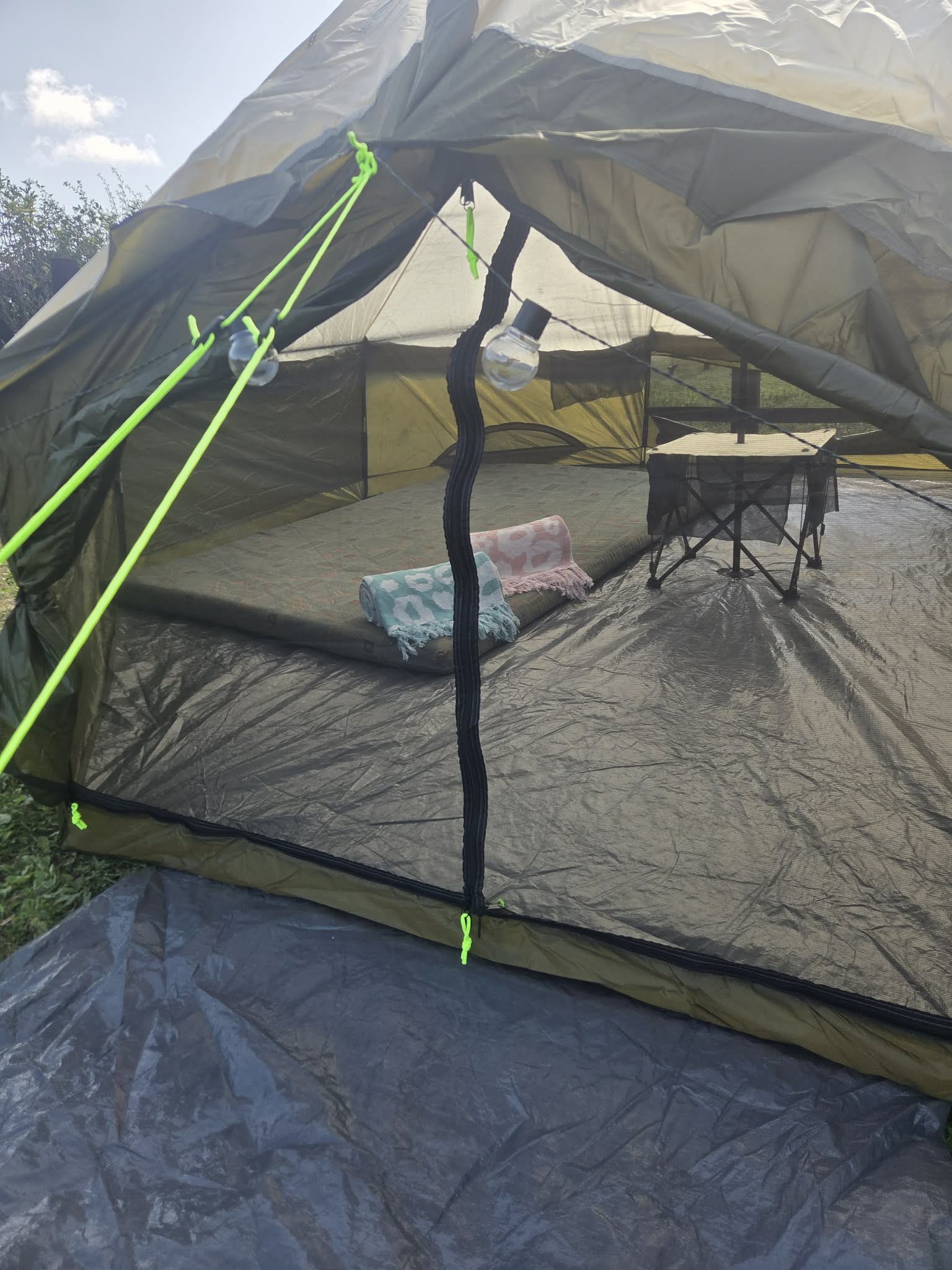 Inside the T-Pee with two double mattresses and folded towels